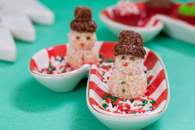 snowmen shaped truffles on a candy cane plate